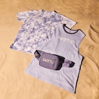 Taylor Swift's Swiftie summer collection 2022 includes purple Fannie packs and more.