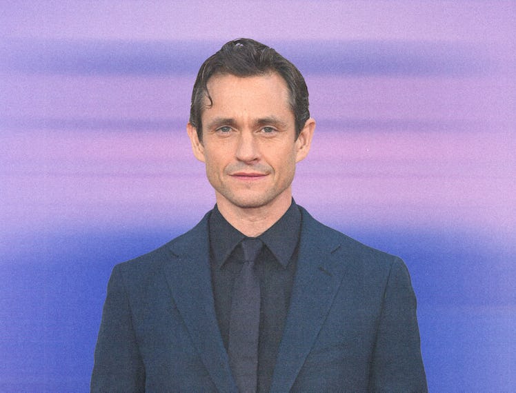 Hugh Dancy wearing a navy suit