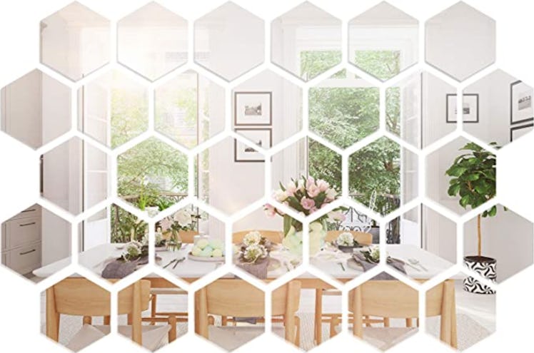 These hexagon mirror stickets are under-$35 items on Amazon that'll make your bedroom look more expe...