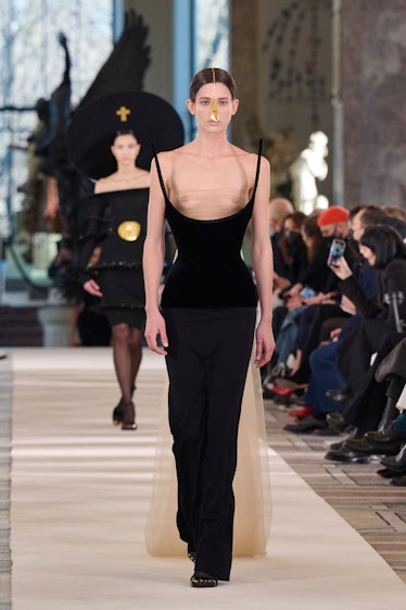 Rachel Marx walks the runway of the Schiaparelli spring 2022 couture show in a dress that exposes he...