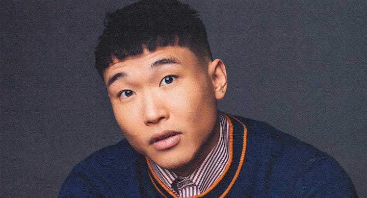 Joel Kim Booster wearing a sweater and collared shirt