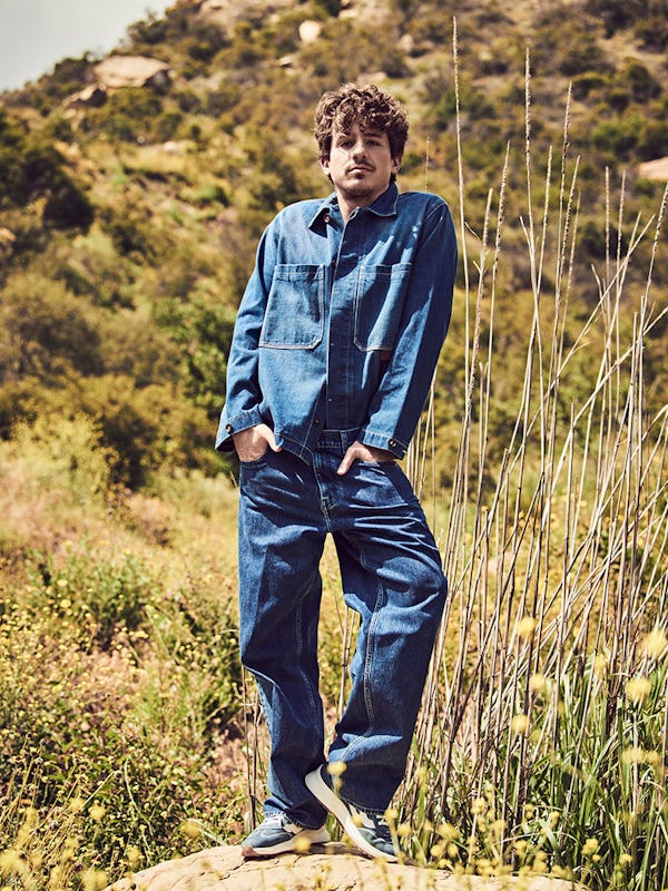 Charlie Puth in a denim Bally shirt and sneakers. and Tommy Hilfiger jeans
