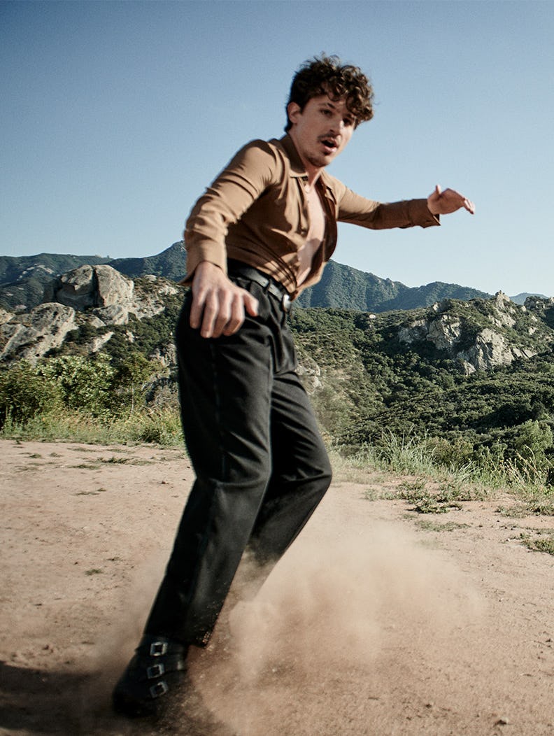 The actor sliding through sand and brings the dust up in a shirt, pants and shoes by Saint Laurent a&hellip;
