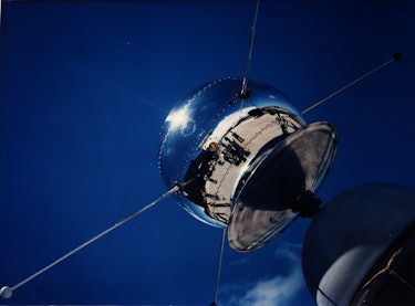 A round shiny orb with four thin prongs sticking out. This is one of the first satellites launched b...