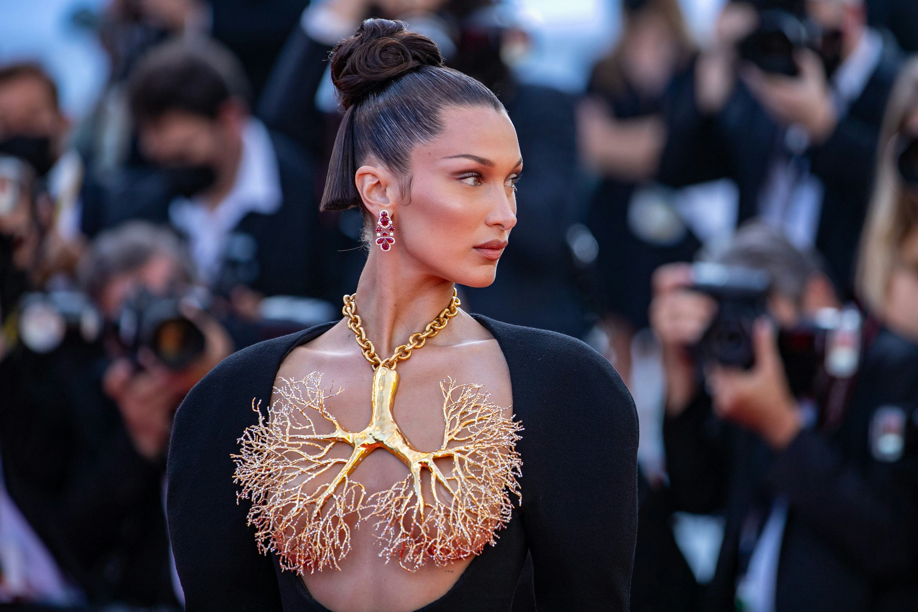 Bella Hadid wearing a large gold necklace in Cannes