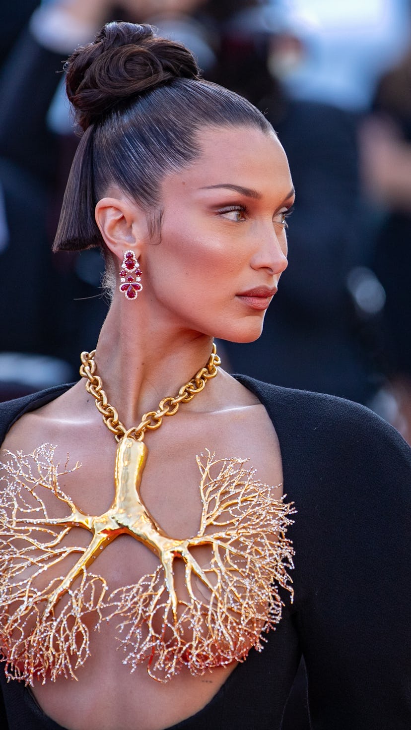 Bella Hadid wearing a large gold necklace in Cannes