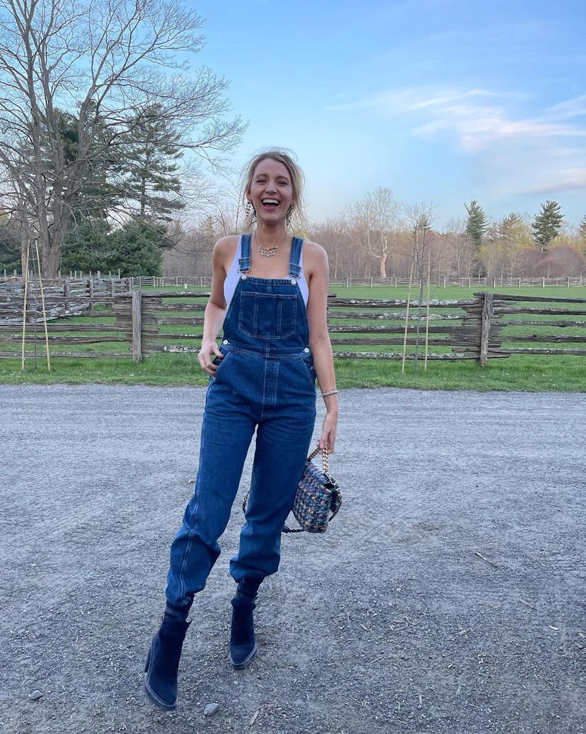 blake lively wearing reformation overalls with navy blue suede hermes boots on april 22, 2022