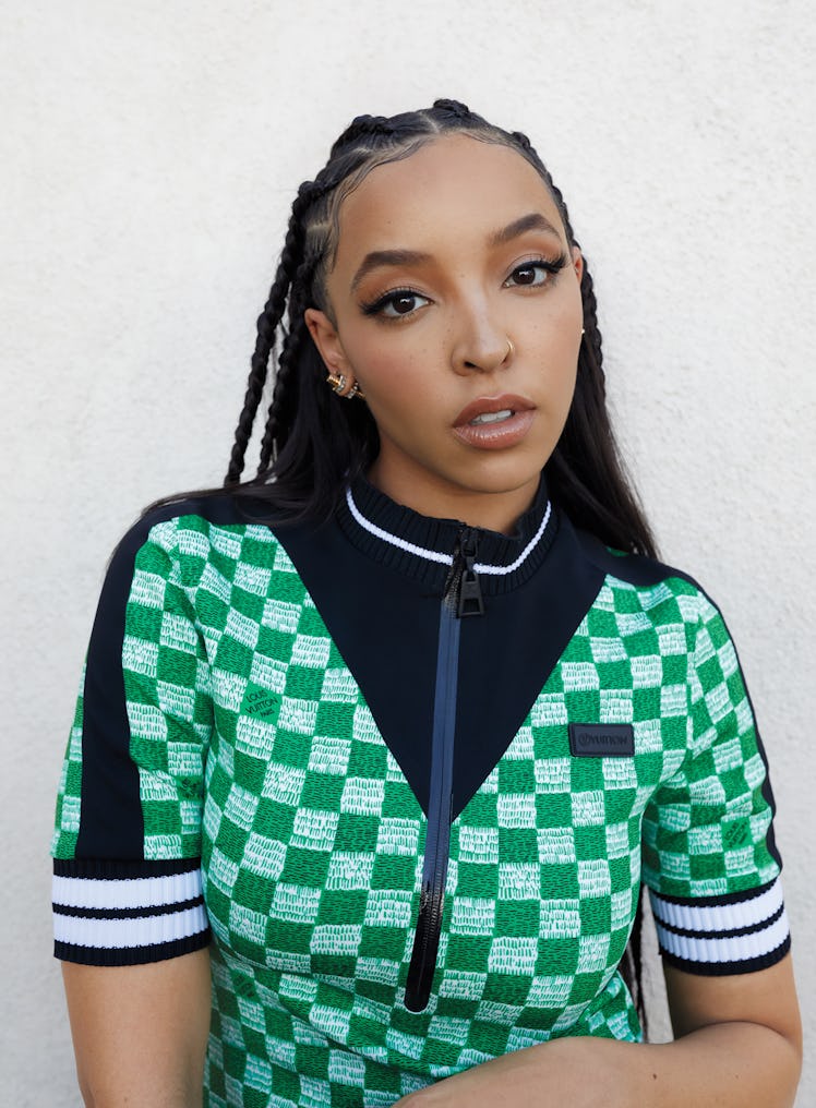 Tinashe wearing a green checkered Louis Vuitton dress and Cartier earrings.