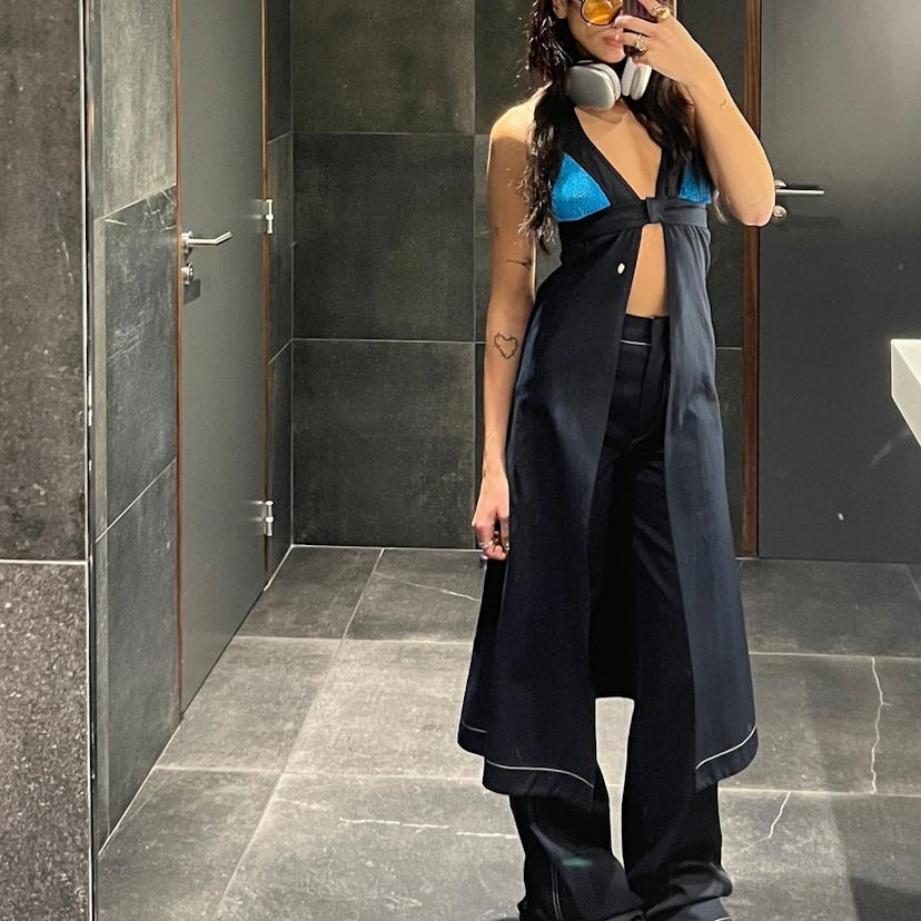 dua lipa wearing a halter dress over jeans 