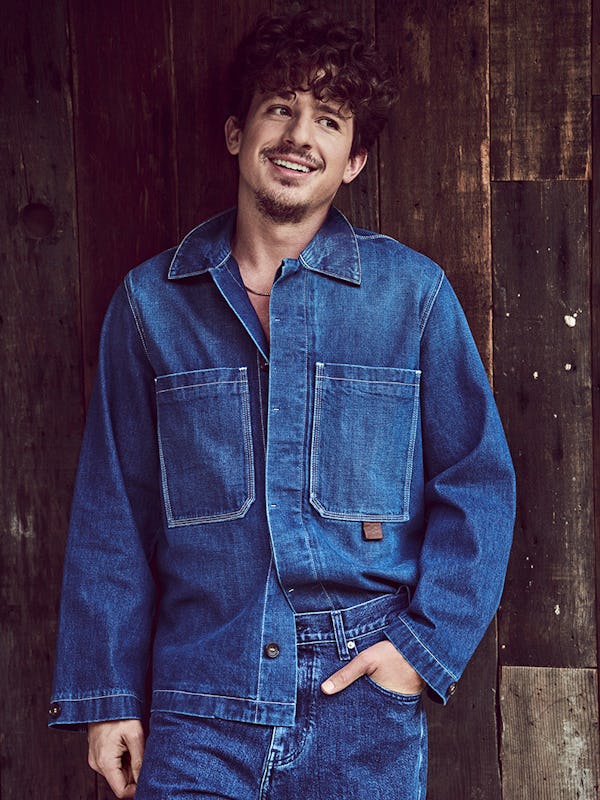 Charlie Puth in a denim Bally shirt and sneakers. and Tommy Hilfiger jeans