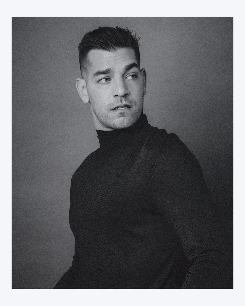 A black and white portrait of Matt Rogers wearing a turtleneck