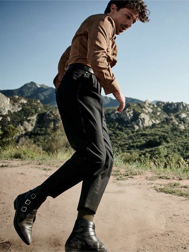 The actor sliding through sand and brings the dust up in a shirt, pants and shoes by Saint Laurent a&hellip;