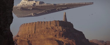 An Imperial star destroyer hovers over Jedha City in Rogue One: A Star Wars Story