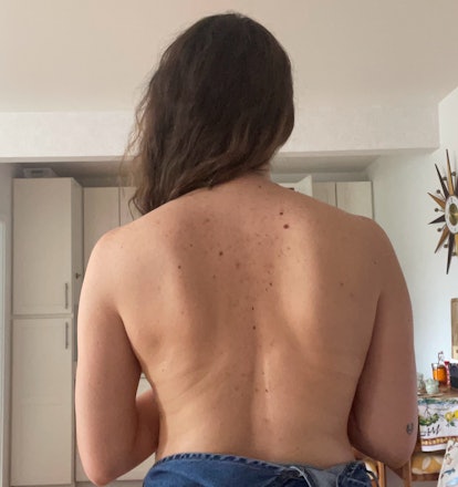 A woman showing off her back. 