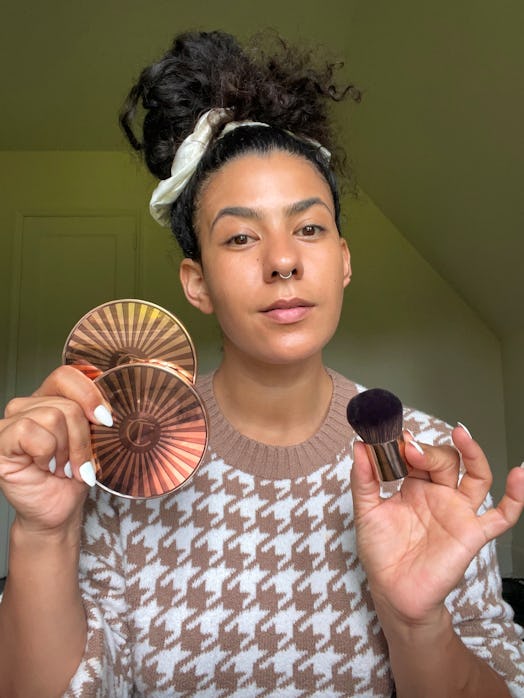 a woman holding Charlotte Tilbury's Beautiful Skin Sun-Kissed Glow Bronzer