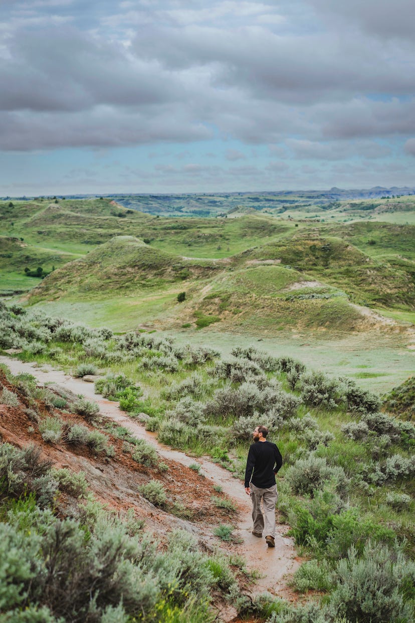 North Dakota as the epic family adventure vacation location for biking - a man walking in the nature