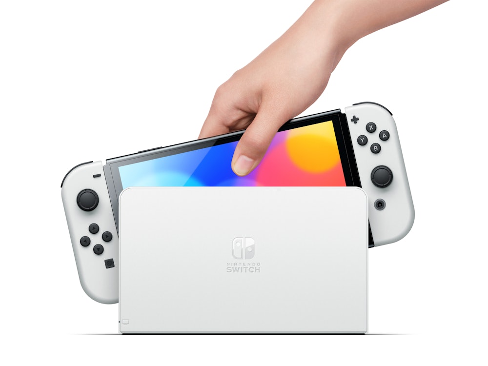 Nintendo Switch OLED with rainbow display mounted in a white dock.