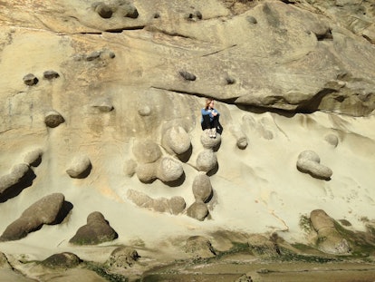 Oregon as the epic family adventure vacation location for camping - a woman sitting on the rocks 