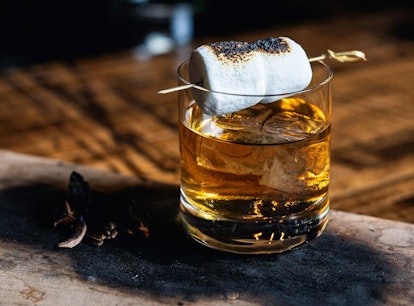 The Colorado Campfire cocktail in a glass with a marshmallow on top of it