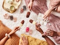 three women wearing the Nails.INC x Magnum Ice Cream nail polish collection eat ice cream.