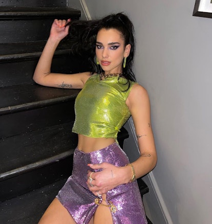 Dua Lipa's heavy black eyeliner and sparkly eyeshadow serve early 2000s nostalgia.