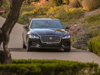 Black Jaguar XF parked on the middle of the road