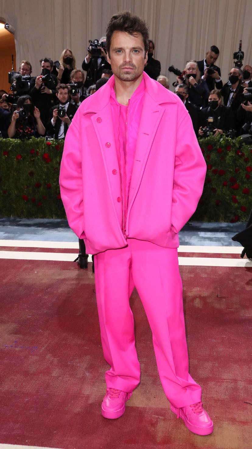 Sebastian Stan stuns in a streetwear-esque, hot pink look at the 2022 Met Gala.