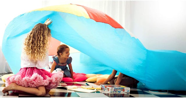 Children playing under the tent indoors