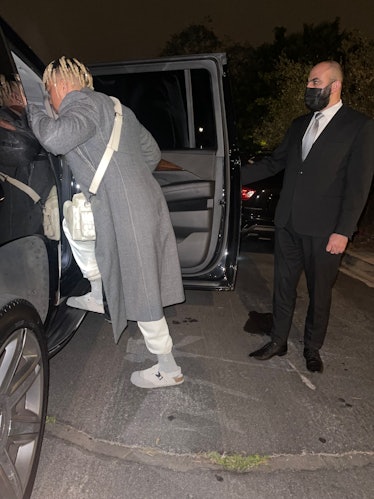 Cordae getting into a car on the way to the Dior Men's show