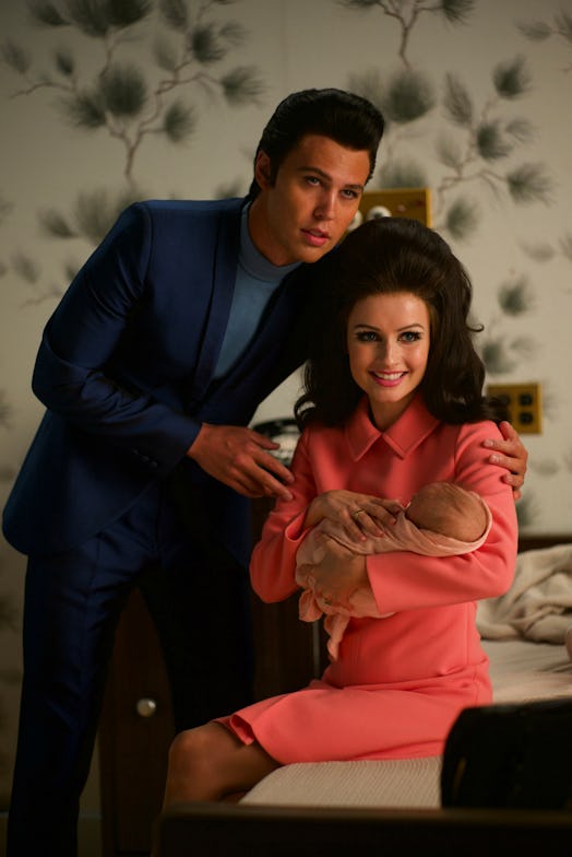 Austin Butler and Olivia DeJonge (holding a baby) wearing Prada in 'Elvis'
