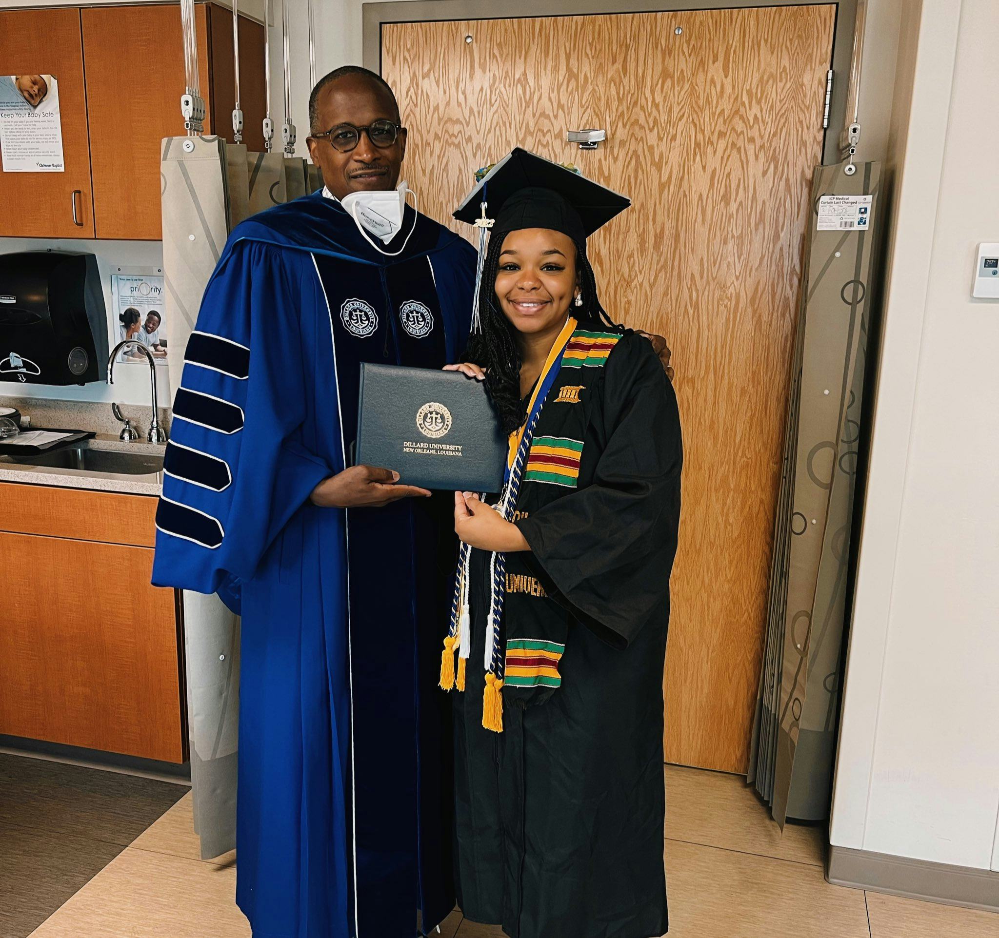 Jada Sayles poses with her degree alongside Dilliard University President, Dr. Walter Kimbrough. 