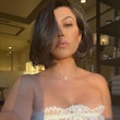 Kourtney Kardashian in white lace bustier