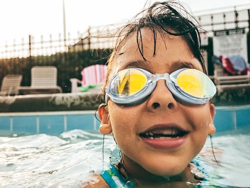 child swimming with goggles, instagram captions for kid's first swim