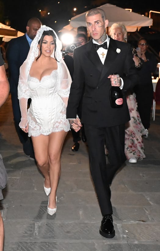 Kourtney Kardashian and Travis Barker’s Italian wedding body language was protective.