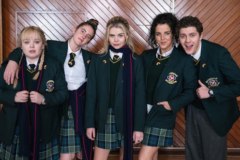 Derry Girls characters Claire, Orla, Erin, Michelle and James pose in their green school uniforms