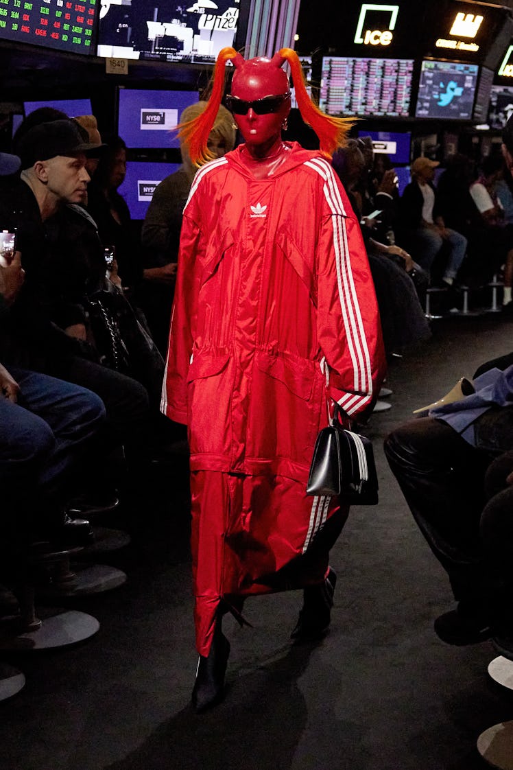 Model in a red Balenciaga x Adidas coat