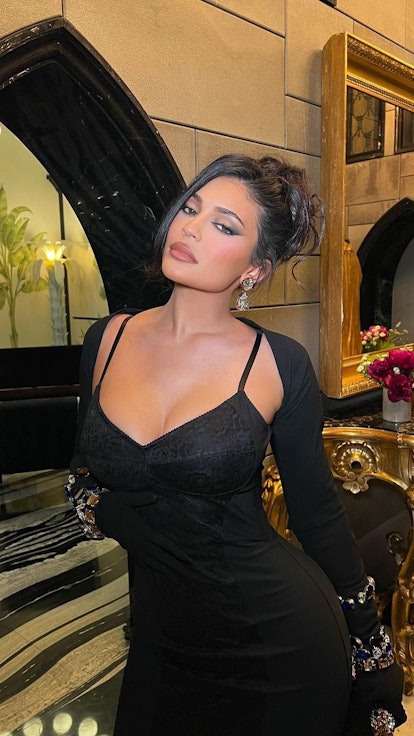 Kylie Jenner posing in a black dress