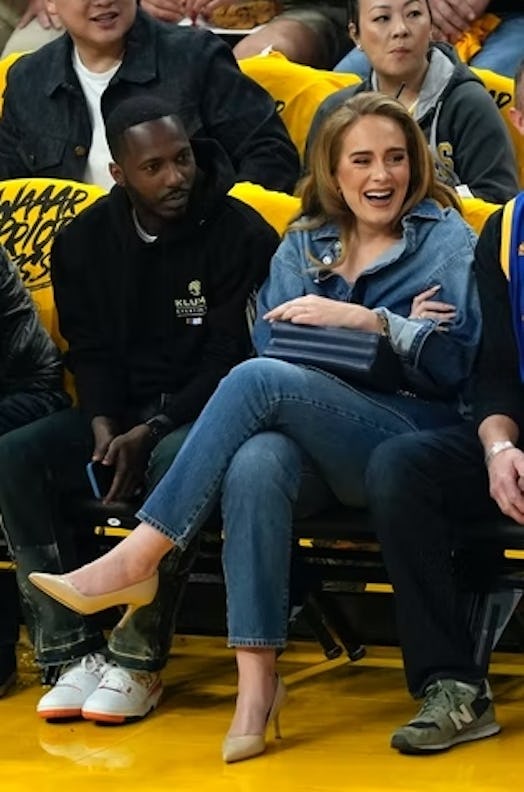 adele wearing an all-denim look with nude pumps at a basketball game on may 20, 2022