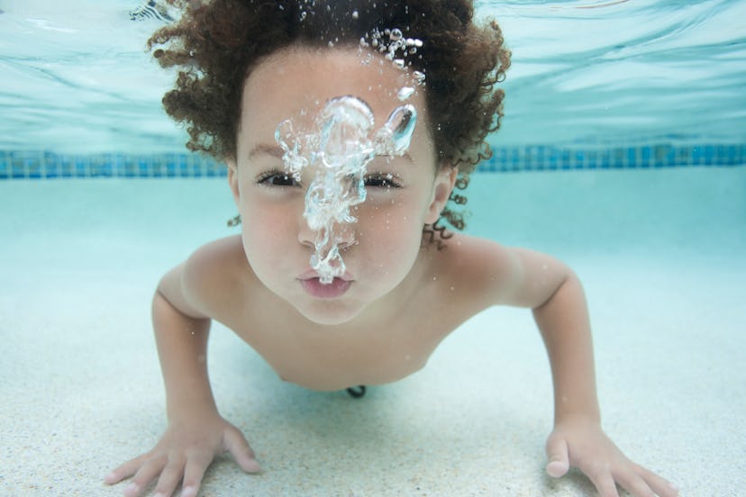 pair this photo of boy blowing bubbles underwater with a cute instagram caption for kid's first swim...