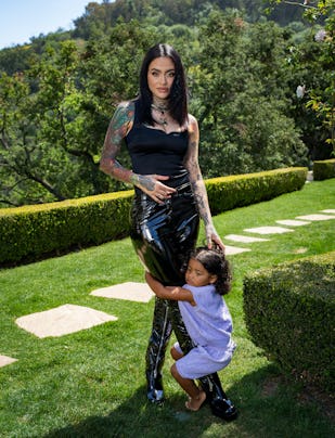 Kehlani posing in a black outfit with her daughter.