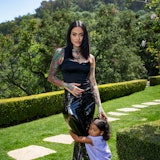 Kehlani posing in a black outfit with her daughter.