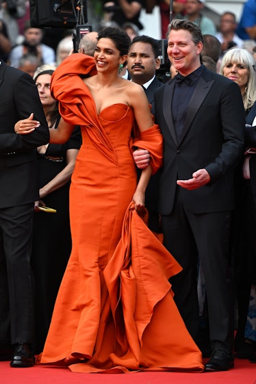 Deepika Padukone wearing an orange gown at the Cannes Film Festival