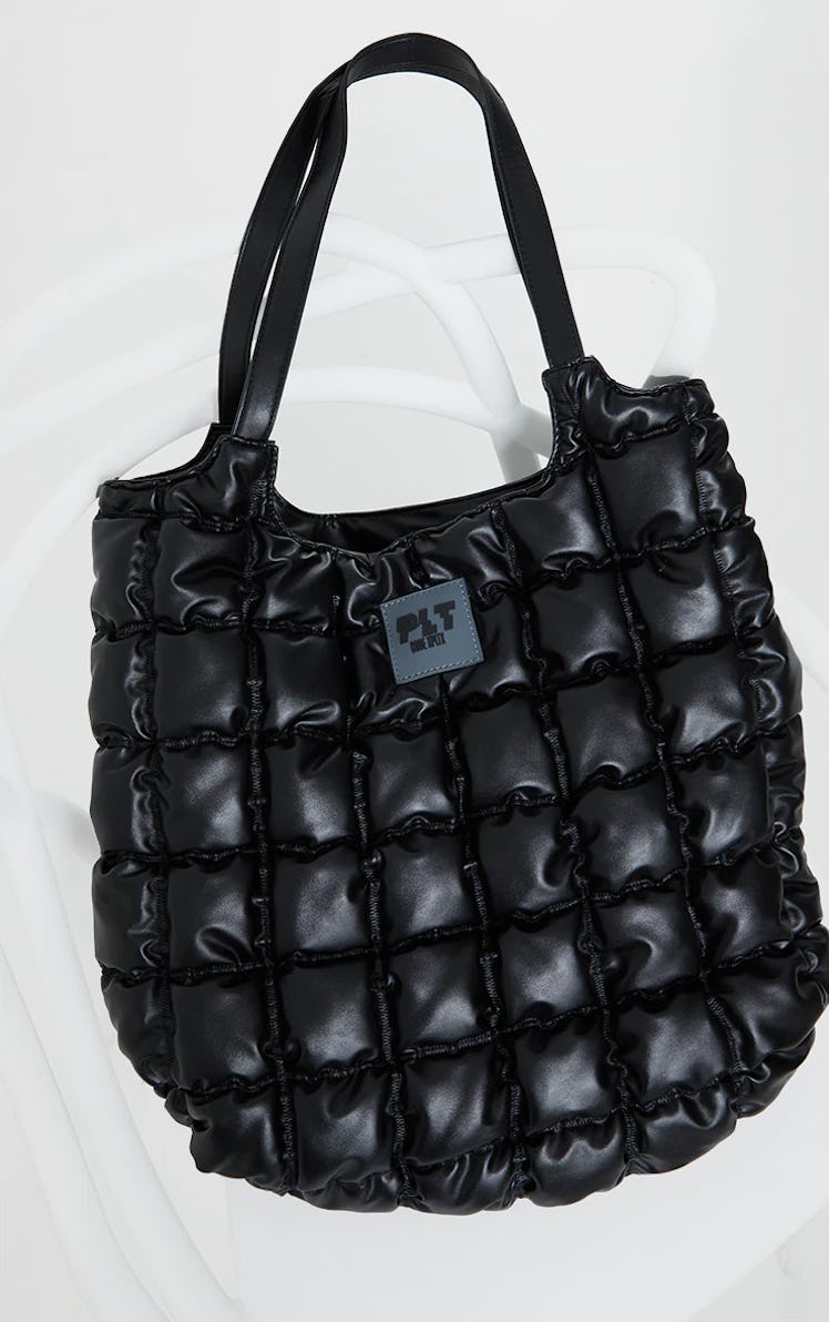 A black, padded tote bag from PrettyLittleThing.