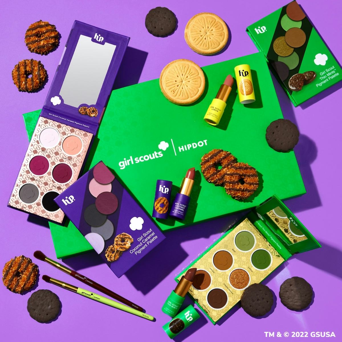 A spread of HipDot's Girl Scout makeup collection including the Thin Mint palette, Coconut Caramel P...