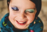 kid with two different eyeshadows wearing beauty products safe for kids