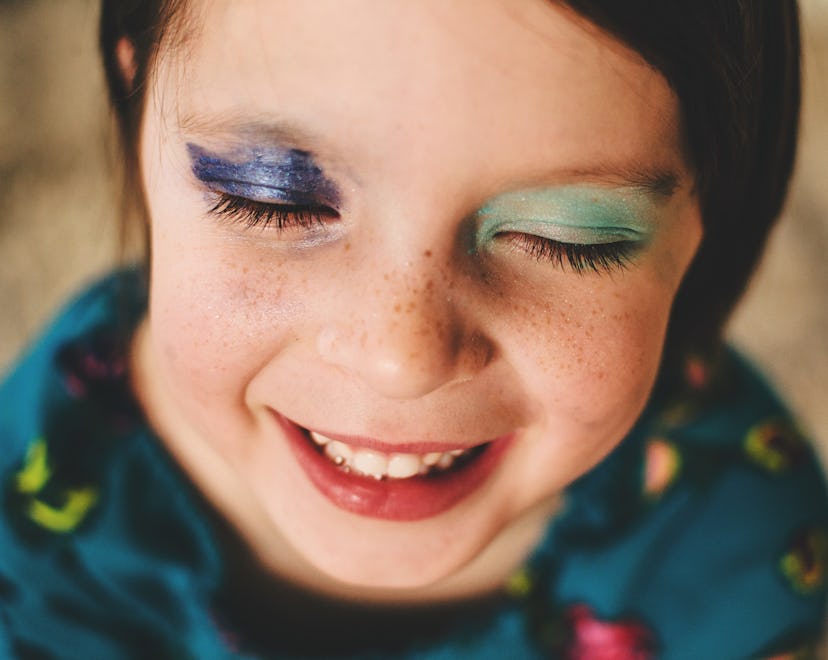 kid with two different eyeshadows wearing beauty products safe for kids