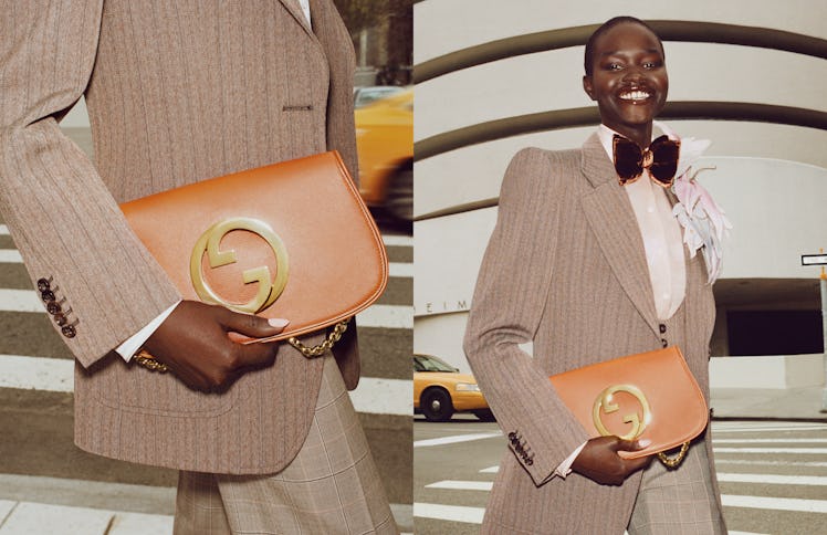 Model in a light brown striped suit and bow tie, displaying a brown leather Gucci bag. 