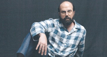 Brett Gelman wearing a blue and white checkered button down with stars of David all over it, jeans, ...