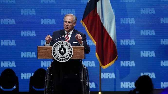 Greg Abbott speaking at the NRA forum with the Texas flag behind him