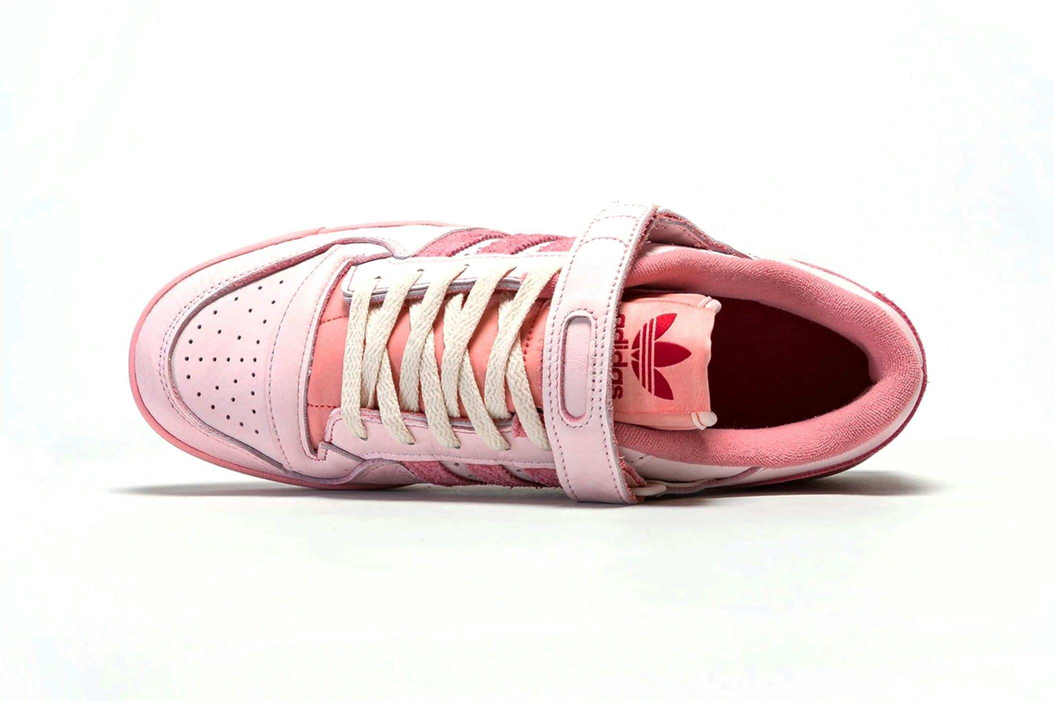 white adidas with pink stripes